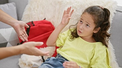 Sticker - Mother and daughter passionately arguing at home on their cozy living room sofa, two family members expressing stress over disagreement