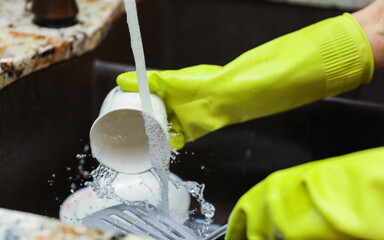 hand-washing dishes, symbolizing equality and shared responsibilities of men and women gender roles responsibilities. Hand washing vs dishwasher technological advances 