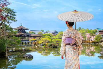 Sticker - Kyoto, Japan - April 2 2023: Heian Jingu Garden is a garden with a variety of plants, ponds and buildings and weeping cherry trees, making it's one of the best cherry blossom spots in Kyoto