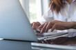 © tippapatt - Business woman hands typing on laptop computer keyboard, surfing the internet on office table, online working, business and technology