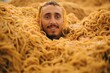 Metaphor. Dunce. A meme template. Noodles. A man with moustache coming to surface from a pile of noodles. A meme about lie. Average TV viewer. Audience. People and spaghetti, pasta. Surrealism. Joyful