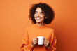 © AI_images - Happy woman with cup of coffee on orange background