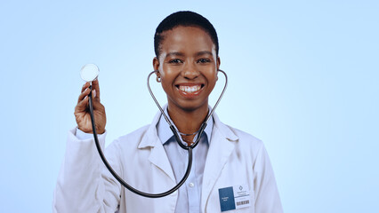 Poster - Happy woman, doctor and stethoscope for healthcare in studio of blue background for mock up in medicine. Portrait, black person and medical professional with smile for wellness, lungs and breathing