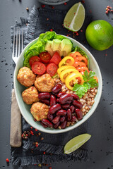 Wall Mural - Spicy Mexican salad with meatballs, beans, groats and pepper.