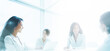 © Viks_jin - Blurry view of female colleagues at desk cooperate discuss business ideas together, multiracial employees businesspeople brainstorm work in group team on project in office. Teamwork concept