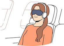 Young Woman Passenger Flight With Blindfold And Earphones Sleeps In Airplane Chair