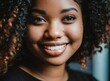© D'Arcangelo Stock - African American curvy hair girl, white teeth smiling closeup
