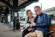 Elderly Couple Travelling Together At The Train Station