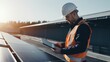 © Space_Background - engineer with laptop and tablet maintenance checking installing solar roof panel on the factory rooftop
