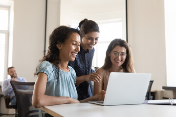 Sticker - Happy joyful female business team brainstorming on online project presentation, using laptop, looking at monitor, making video call, smiling, laughing. Cheerful diverse colleagues enjoying teamwork