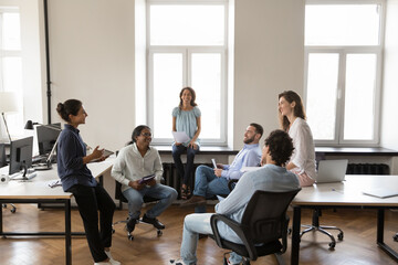 Poster - Cheerful inspired motivated business team discussing successful project in office, brainstorming, talking, laughing, celebrating high sales result. Multiethnic creative group working together