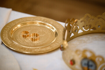 Wall Mural - Wedding rings stand on a tray in the church for consecration with water.