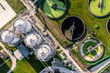 Aerial view above waste water treatment plant with water storage tank