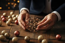 Decision Making Concept. Hands Of A Businessman Building A Puzzle Of Wires And Balls On A Wooden Surface With Scattered Spotted Balls