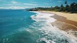 Paradisiacal beach in Taipu de Fora, on the coast of Bahia, in northeastern Brazil. Waves breaking in the sea, with sand without people and cloudy summer sky