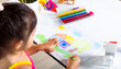 © sorapop - Asian cute kid preschooler sit on table smile she draw country house picture with pencil at home to learning arts homework, Happy child little girl colorful drawing landscape my home dream on paper