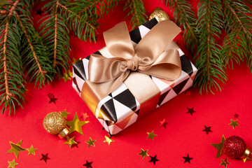 Christmas New Year background. gift box and christmas decorations  at red background.