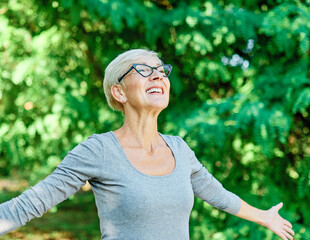 Wall Mural - woman senior happy retirement elderly dreaming relaxation meditation nature active imagination daydreaming  harmony freedom carefree wellbeing