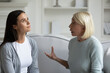 © fizkes - Strict anxious mature mother lecturing scolding annoyed grown daughter, sitting on sofa at home, parent and child quarrel, generations conflict, stubborn young woman ignoring angry senior mum