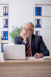 © Elnur - Old male employee and too much work in the office