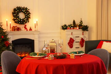 Poster - Cozy living room with Christmas tree near fireplace and table served for celebration. Interior design