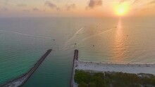 Sunset Seascape Of Rock Jetty Barrier And Boats Sailing At Harbor On Colorful Ocean Water Near Venice And Nokomis Beach In Sarasota County, USA