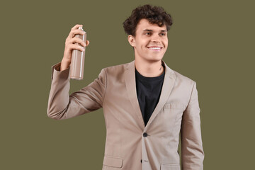 Poster - Handsome young man with bottle of hair spray on green background