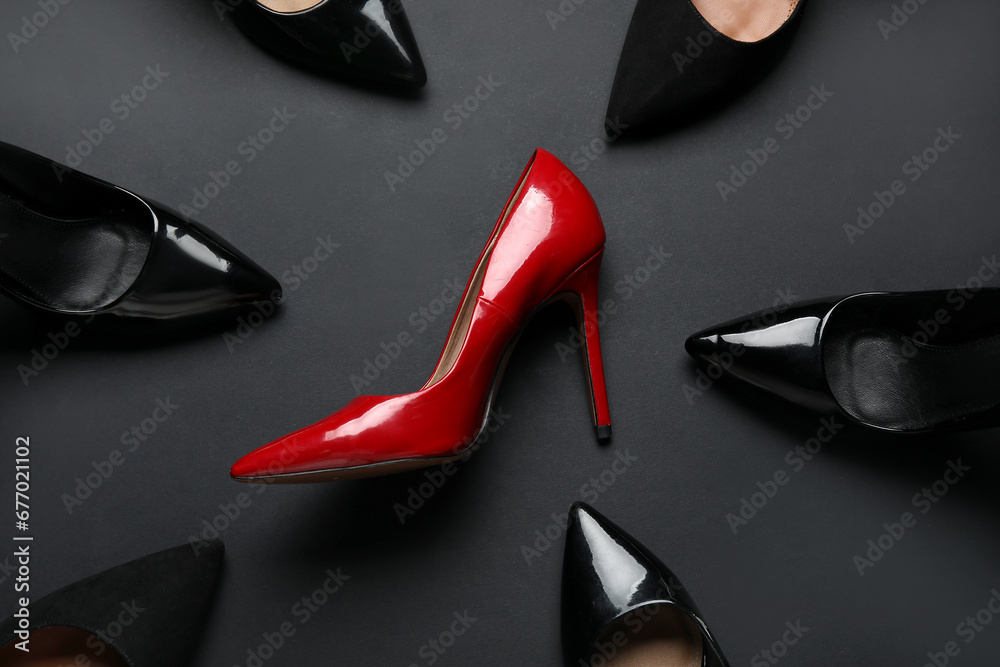 Different stylish high heels on black background