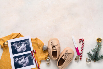 Sticker - Composition with sonogram image, baby clothes and Christmas decorations on light background