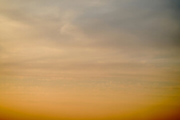 Wall Mural - Evening clouds in the sunset sky in the light of the rays of the setting sun