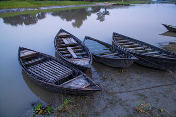 landscape view of Traditional wooden fishing boats on the shore of the Padma River in Bangladesh