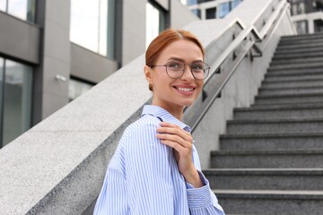 Poster - Portrait of beautiful woman in glasses outdoors, space for text