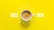 Happy new year and Merry Christmas 2024. Cup of coffee change and download 2023 to 2024 on yellow background. Start up and New Year Concept. Copy space