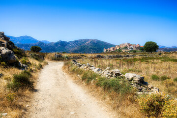 Wall Mural - The Old Road Leading to the Beautiful Medieval Village of Sant’Antonio on a Hilltop in the Balagne Region on Corsica