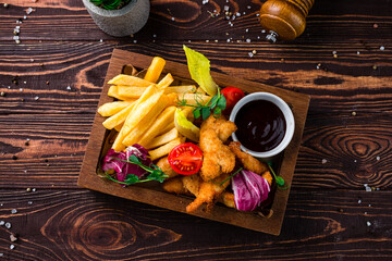 Canvas Print - Fried breaded chicken fillet with French fries, cherry tomatoes, lettuce and sauce.