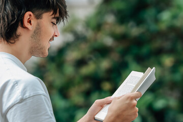 Wall Mural - young man with book on the street outdoors