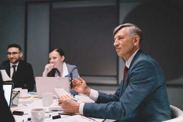 Wall Mural - Focused businessman analyzing diagrams in conference