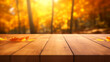 The empty wooden table top with blur background of autumn. Exuberant image. autumn landscape. Concept Autumn nature and product advertising. soft focus background. copy space.
