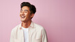 smiling handsome vogue Asian man on solid color background