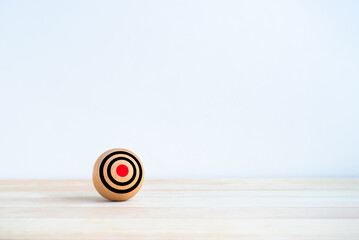 Wall Mural - Focus on small target groups, business goal concepts. Target dart icon on wooden sphere ball without arrow on red spot, bullseye dartboard, isolated on white background with copy space, minimal style.