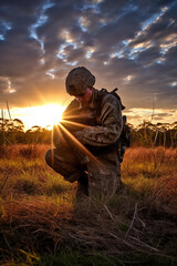 Wall Mural - Photograph of a soldier kneeling after praying at sunrise.