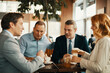 © Geber86 - Diverse business friends having coffee after work in cafe