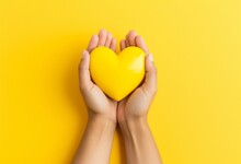 Hands Holding A Yellow Heart