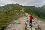 Fototapeta Dmuchawce - young tourist on a mountain trail in the Tatra Mountains