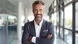 © Fred - portrait of successful senior businessman consultant looking at camera and smiling inside modern office building