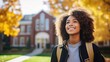 Portrait of a smiling young black female student on colledge campus in the fall ready to start school year 