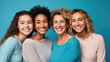 Four happy women of different ages and ethnic backgrounds, with bright smiles, posing together against a vibrant blue background.