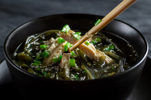 Korean Cuisine. Healthy Meals For Pregnant Women. Seaweed Soup With Meat In A Black Bowl. Birthday Soup. Tradition. Custom. Close-up.