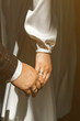 Hands of newlyweds with wedding rings.