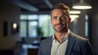 © Naknakhone - Handsome business man smile in office. Man very happy. Successful mature businessman looking at camera with confidence.